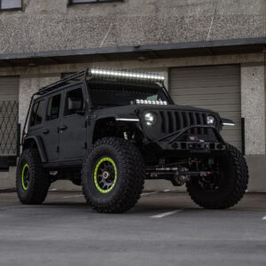 a black jeep with green rims