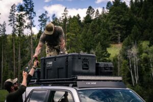 Two Men Loading Up Storage Boxes on a GOBI Racks Roof Rack on Top of a Toyota 4Runner