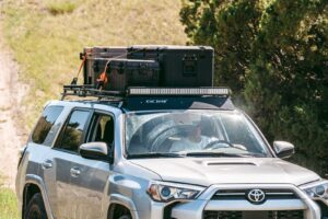 Man Driving a Silver Toyota 4Runner with a GOBI Racks Roof Rack Attached