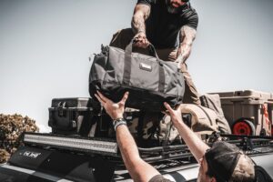 Two Men Loading Bags onto a GOBI Racks Roof Rack