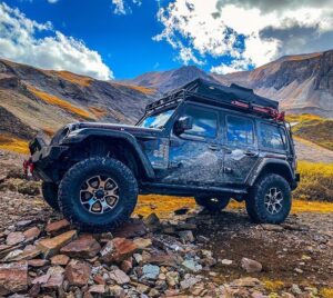 Black Jeep with a GOBI Racks Roof Rack Driving on Mountain Trail