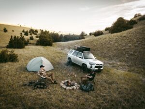 Two Men Camping in Woods with GOBI Racks Roof Rack on Their Silver Toyota 4Runner