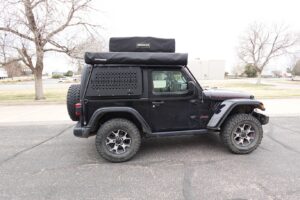 Jeep Wrangler JL 2 Door MOLLE panel side view with overland gear mounted black steel storage system GOBI style